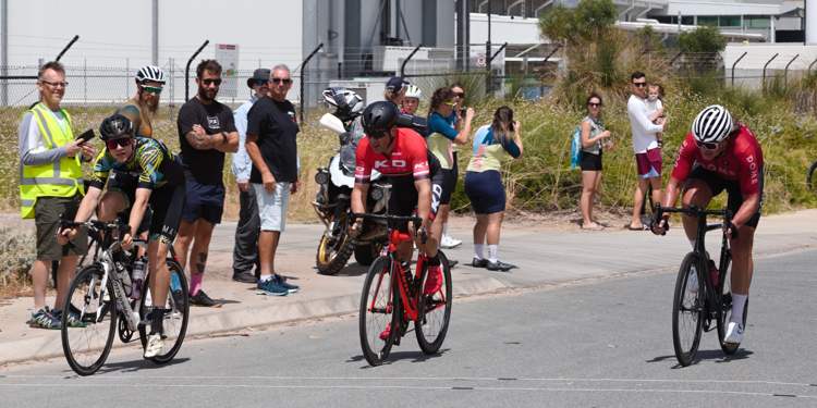 three cyclists crossing finish line
